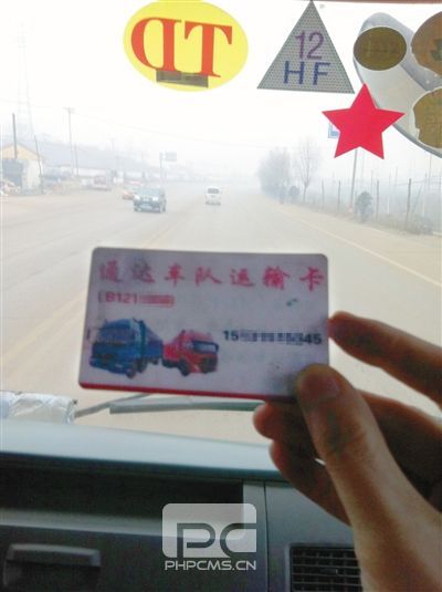 12月8日，迁西司机张田车上的“车队”联系卡，货车前风挡上，还贴有“TD”和“HF”字样的“保护牌”。他说这都是向当地“车队”购买超载“保护牌”后获得的标志，治超人员见到“保护牌”后，就会放行。